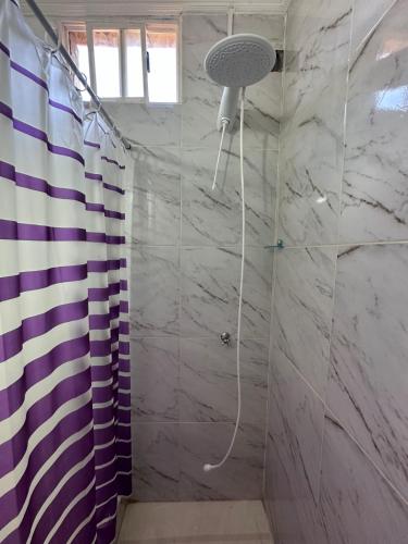 a bathroom with a shower with a shower curtain at Aguara Falls in Puerto Iguazú