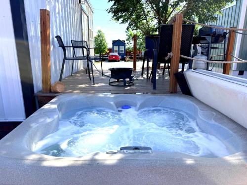 a jacuzzi tub sitting on top of a patio at Pet-Friendly Basecamp Near Zion National Park in Apple Valley