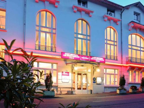a building with a sign on the front of it at Mercure Saint Nectaire - Spa & Bien-Être in Saint-Nectaire
