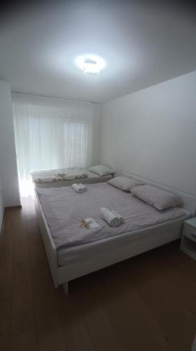 a bedroom with a bed with two towels on it at Apartman Galić Posušje in Posušje
