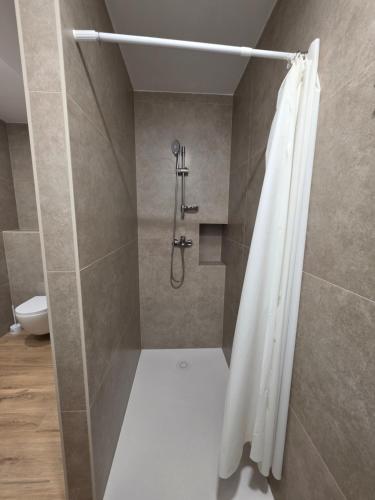 a bathroom with a shower with a shower curtain at Apartman Galić Posušje in Posušje