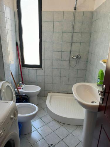 a bathroom with a sink and a toilet and a shower at Apartament M&L in Golem