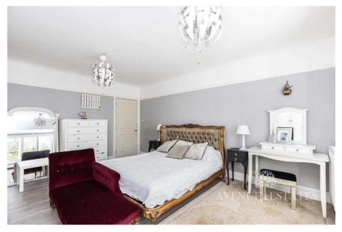 a bedroom with a bed and a red chair at Double rooms in shared house in Bournemouth