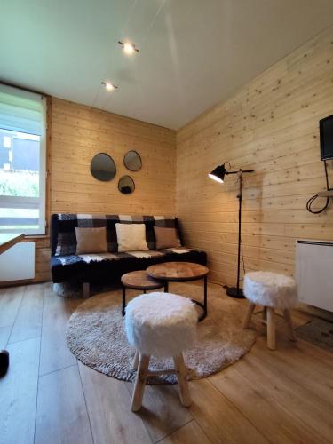 a living room with a couch and a table at L'Esprit Boisé in Ustou