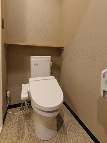 a bathroom with a white toilet in a room at Astil Hotel Shinosaka Precious in Osaka