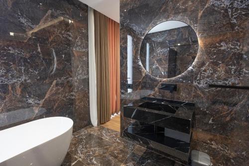 a bathroom with a sink and a mirror at Aria Luxury Villa 2 in Dhërmi