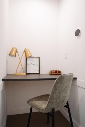 a desk with a chair and a picture and a lamp at Frontcountry Salida in Salida