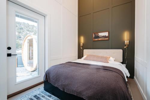 a bedroom with a bed and a large window at Frontcountry Salida in Salida