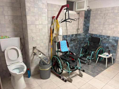 a bathroom with twochairs and a toilet and a sink at Angela Apartments in Igoumenitsa