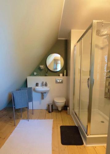 a bathroom with a toilet and a sink and a shower at Cherry Tree Cozy Rooms in Gdańsk