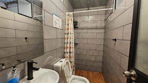 a bathroom with a sink and a toilet at Lima Airport Hostel - FREE AIRPORT PICK UP in Lima