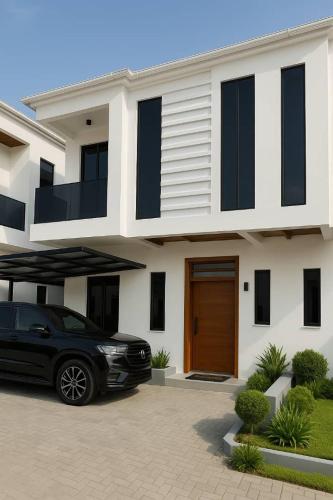 a black car parked in front of a house at Lekki Luxe 4BR Retreat in Lekki