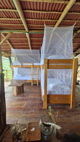 a bedroom with a bed with a mosquito net at Ecologic Mountain Cabin, amazing view in Santa Marta