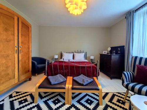 a bedroom with a bed with a red blanket at Cherry Tree Cozy Rooms in Gdańsk