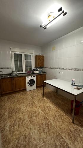 an empty kitchen with a table in the middle of a room at AMANECER ZEN in Argés