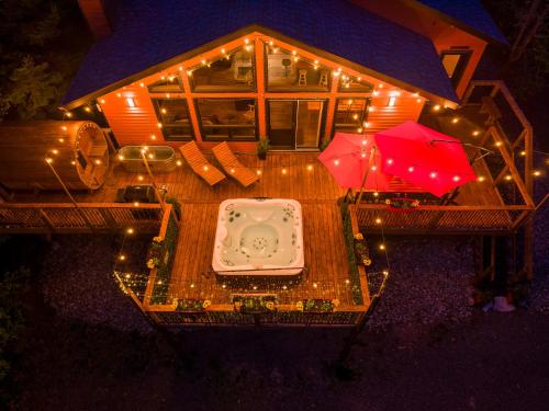 an overhead view of a house with a table and two umbrellas at Ask us for our immersive 3D virtual tour before reservation in Lac-Superieur