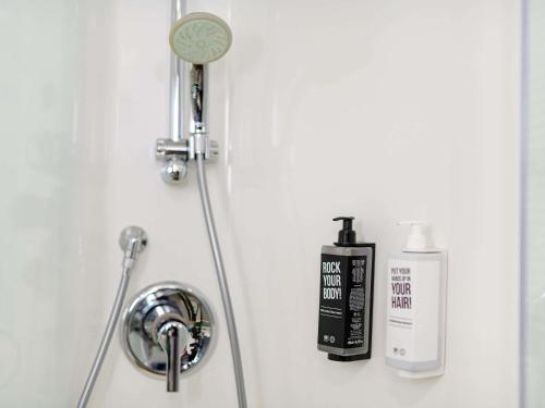 a shower head and a blow dryer on a wall at ibis Köln Frechen in Cologne