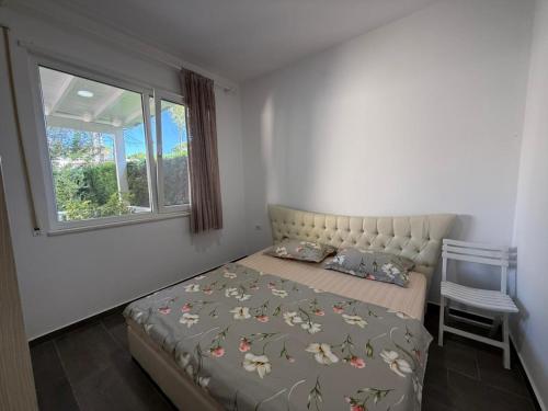 a bedroom with a bed and a window at Beach Garden Home, Lalzi Bay in Draç