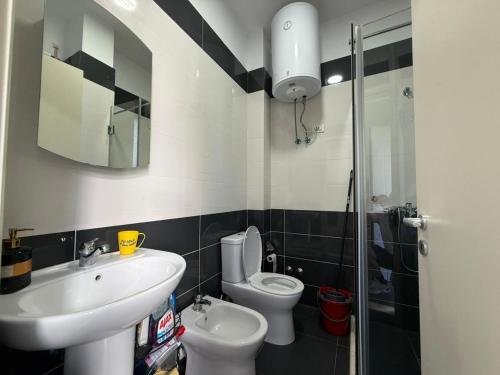 a bathroom with a sink and a toilet and a shower at Beach Garden Home, Lalzi Bay in Draç