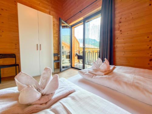 a bedroom with a bed with pillows and a large window at Rattendorf 15B in Rattendorf