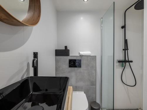 a bathroom with a shower and a sink and a toilet at De Nordic Escape in Warmenhuizen