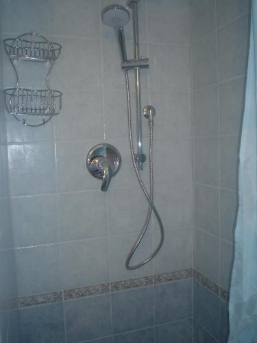 a shower with a shower head in a bathroom at Villetta Lucia in Sperlonga