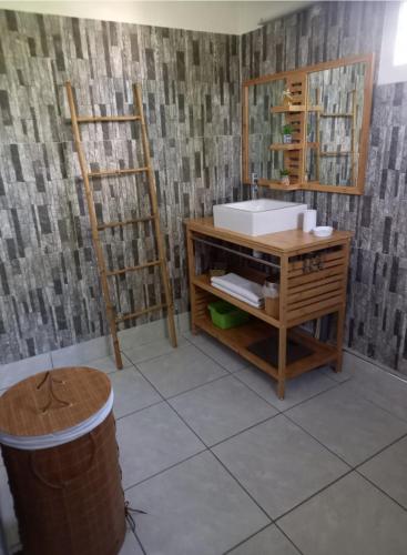 a bathroom with a sink and a mirror at O baobab in Saint-François
