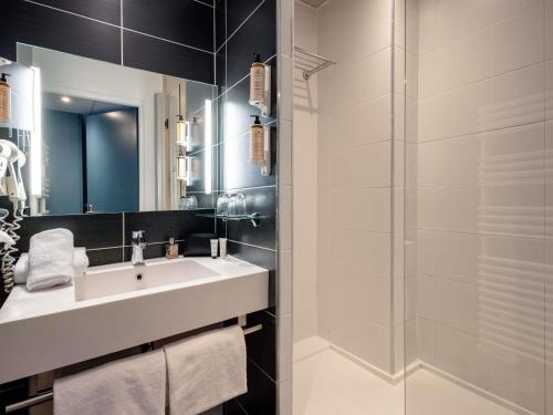 a bathroom with a sink and a shower at Mercure Annecy Centre in Annecy