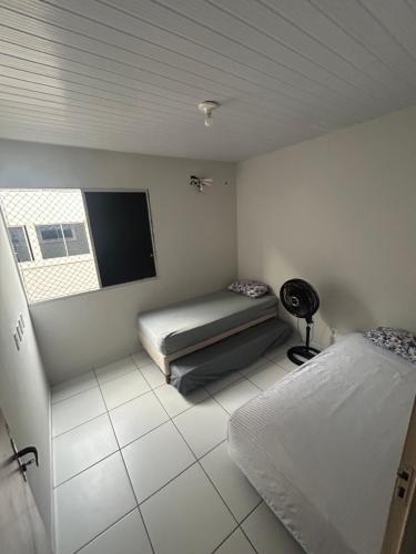 a bedroom with a bed and a flat screen tv at Ap Turquesa in Teresina