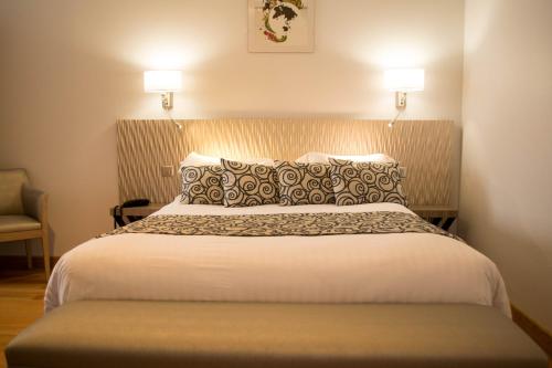 Un ou plusieurs lits dans un hébergement de l'établissement Hôtel Restaurant Des Remparts