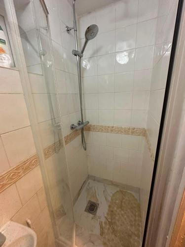 a shower with a glass door in a bathroom at Heathrow Ensuite in West Drayton