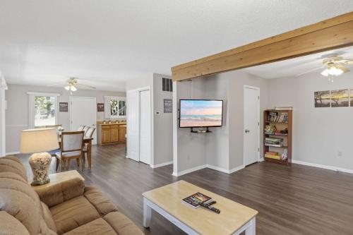 a living room with a couch and a tv at Private Dock-Deck-LakeHouse-Lake Front-3bd 2bth in Lake Ozark