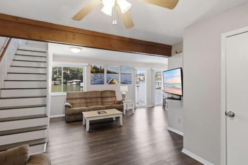 a living room with a couch and a table at Private Dock-Deck-LakeHouse-Lake Front-3bd 2bth in Lake Ozark