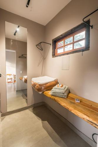 a room with a bed and a window on the wall at Casa Jabu in Catas Altas