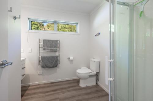 a bathroom with a toilet and a shower at Pohara Retreat in Pohara