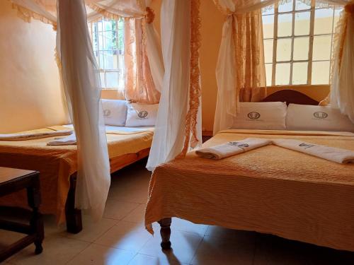 a bedroom with two beds and a window at Scenic View Hotel and Resort in Thika