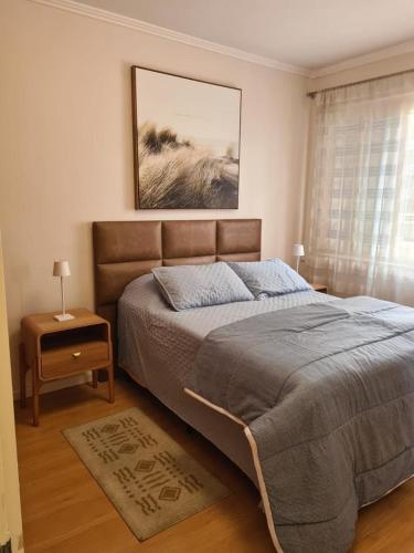 a bedroom with a large bed and a window at Ap Central 3 quartos com elevador e garagem in Pelotas