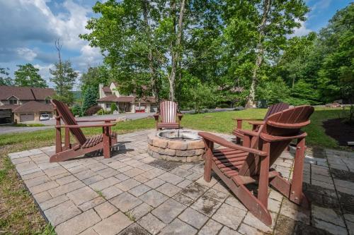 three wooden chairs and a table and a fire pit at Gulfway Hideaway in Oakland