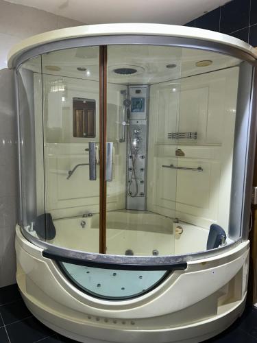 a bathroom with a shower in a room at Villa Char in Accra