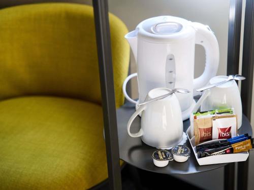 a table with a blender and a yellow chair at Ibis Praha Wenceslas Square in Prague