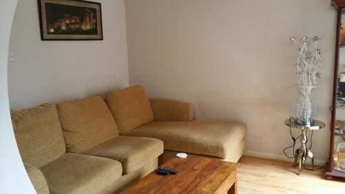 a living room with a couch and a table at Maindee Guest House in Barrow in Furness