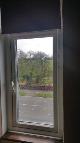 a window in a room with a view of a field at Maindee Guest House in Barrow in Furness