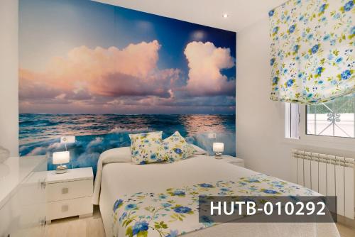 a bedroom with a mural of the ocean at Apartamento Roca Mar in Sitges