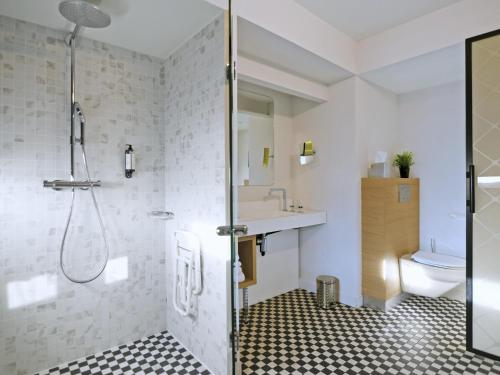 a bathroom with a shower and a sink at Mercure Nantes Centre Gare in Nantes