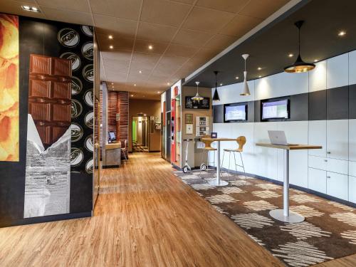 an office with a hallway with a desk and a table at ibis Winterthur City in Winterthur