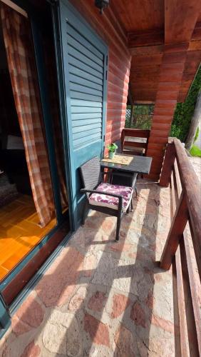 a patio with a table and chairs on a porch at Family Apartments in Žabljak