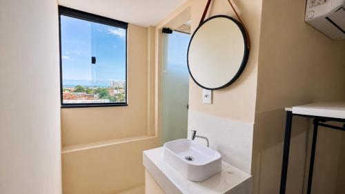 a bathroom with a sink and a mirror at Made Hotel in São Luís