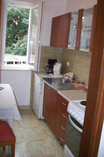 a kitchen with a sink and a counter top at Captain's villa in Molunat