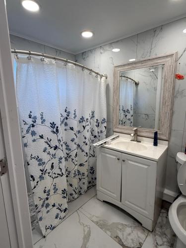 a bathroom with a sink and a shower curtain at Studio sunshine in St. Petersburg