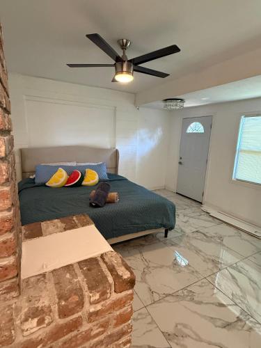 a bedroom with a bed and a ceiling fan at Studio sunshine in St. Petersburg